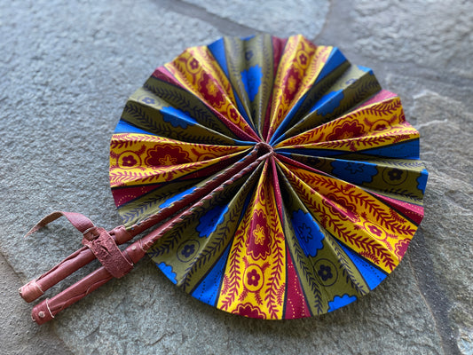African wax print artisan fan in yellow, red, and blue with goat leather